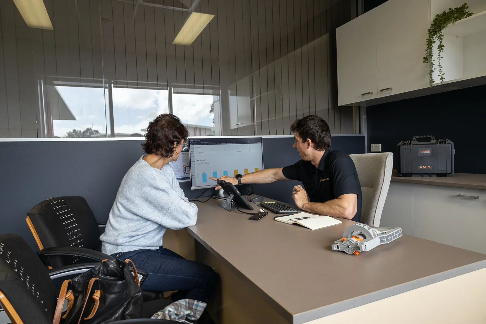 A Longevico clinician discussing health results during a consultation