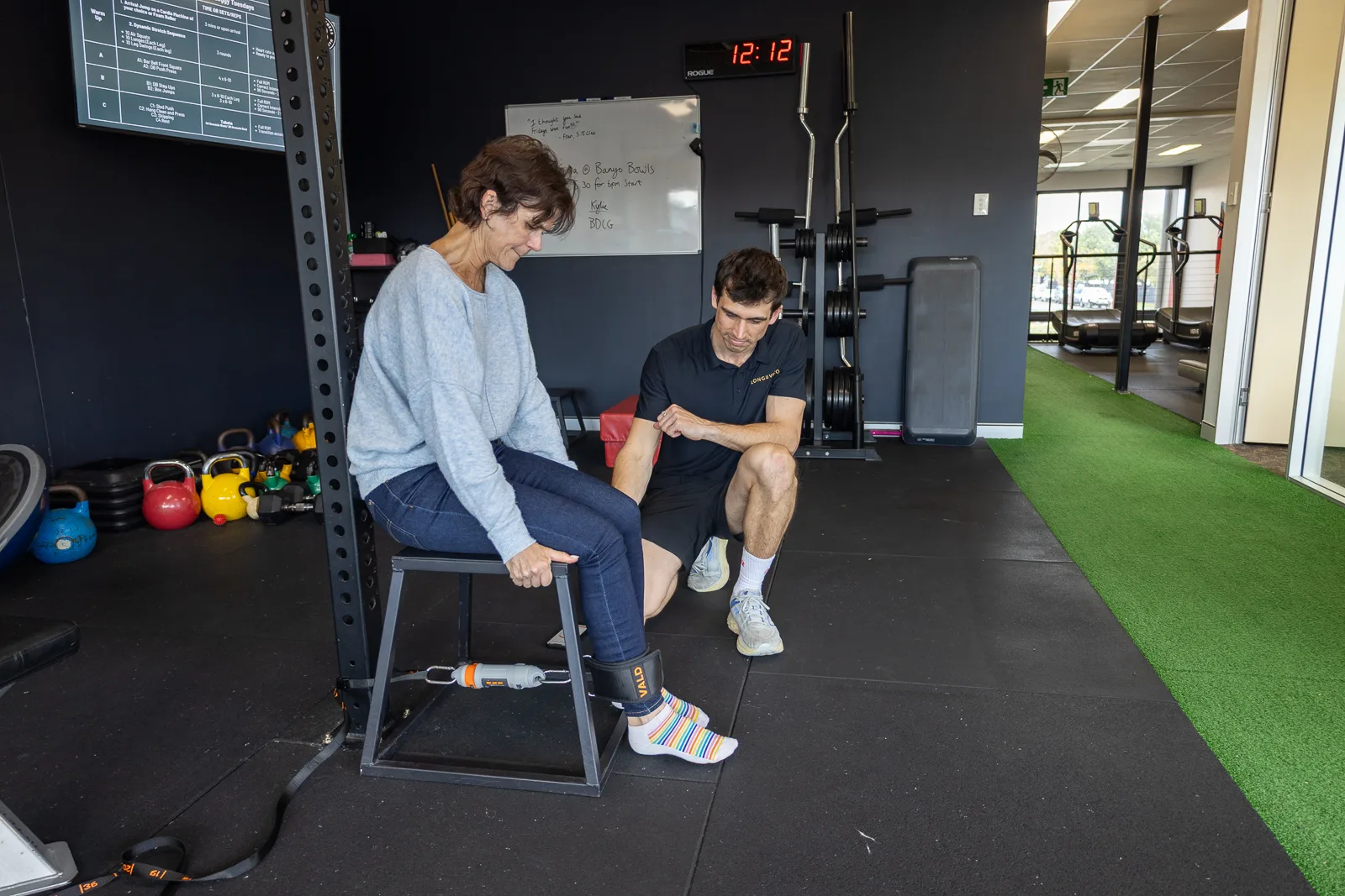 A Longevico clinician conducting a functional movement assessment
